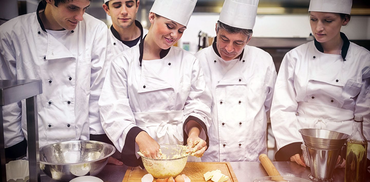 Pastry chef showing students how to prepare dough PREP